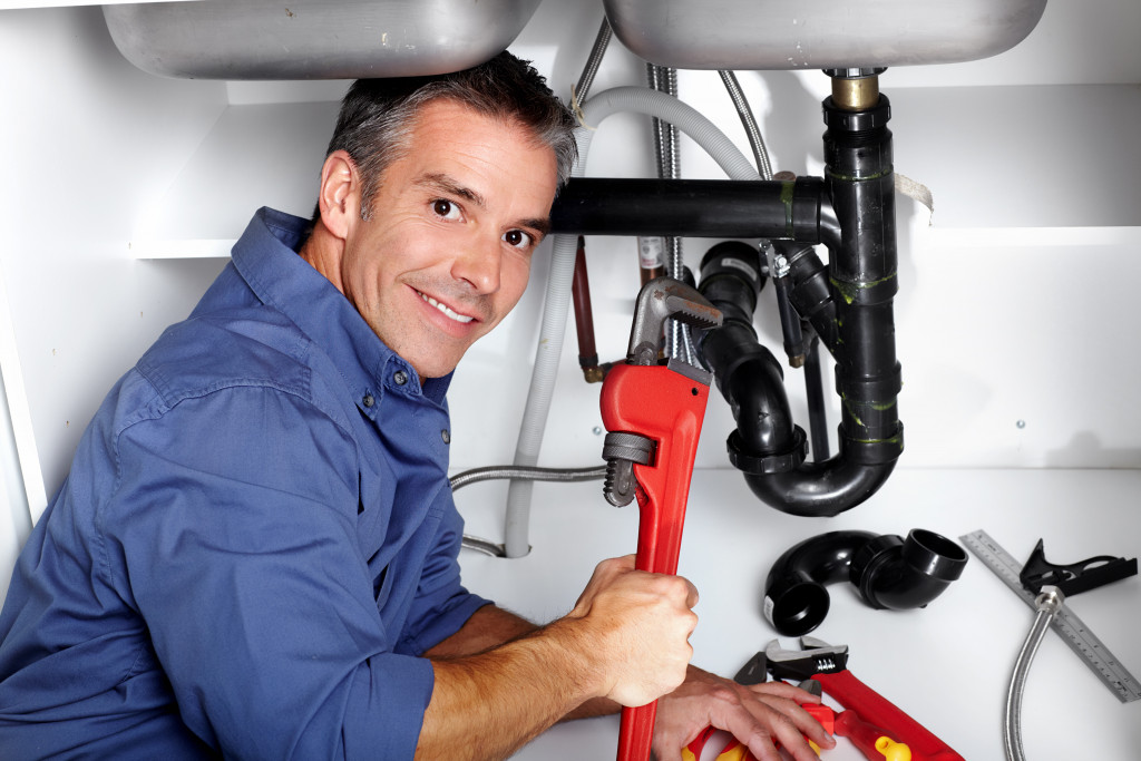 man plumbing and holding a wrench