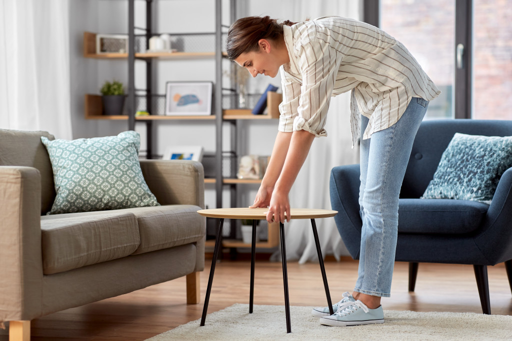 woman adding a coffee table in the living room