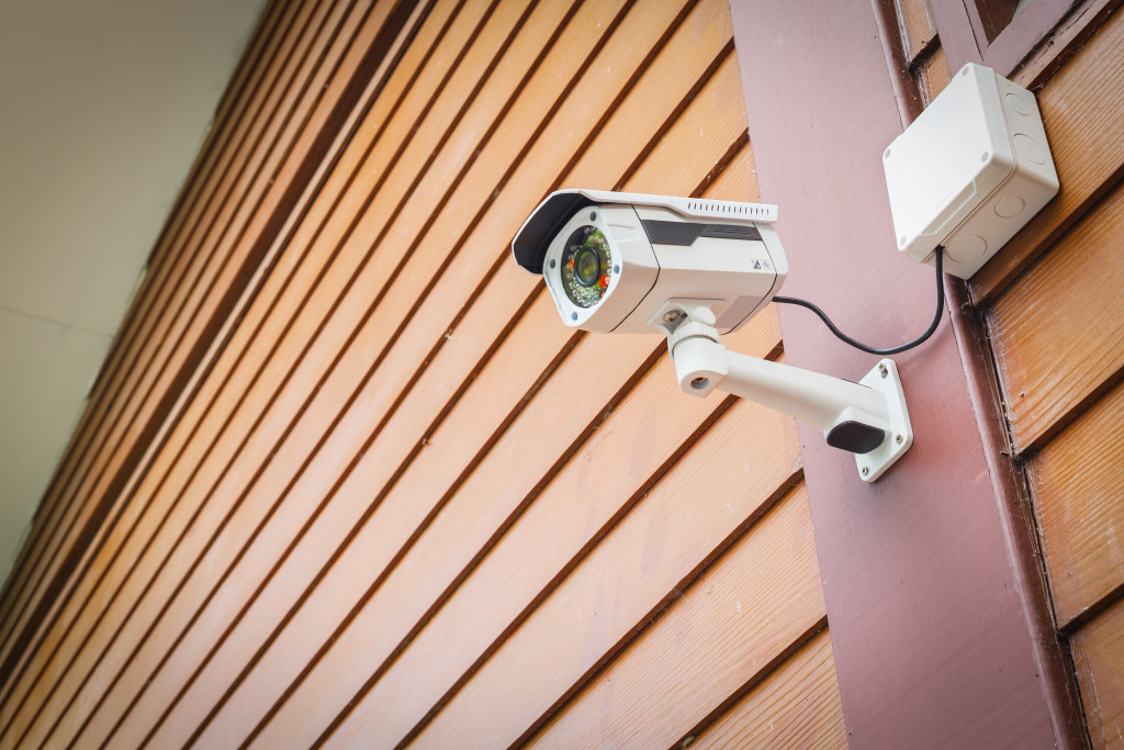 a surveillance camera installed in a house's wall