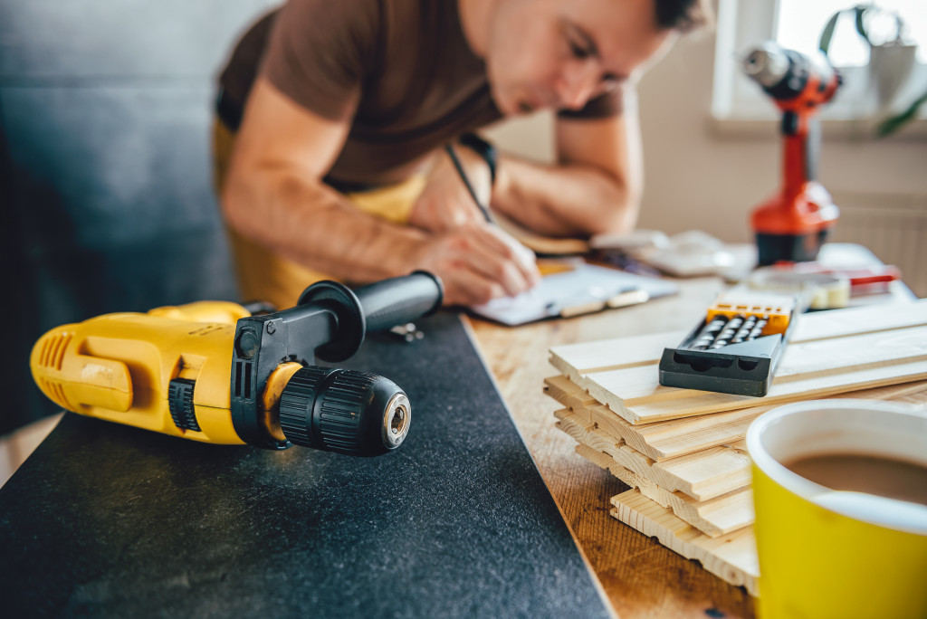 Homeowner installing new flooring in a house.