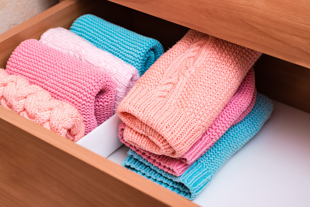 An organized drawer with folded clothes