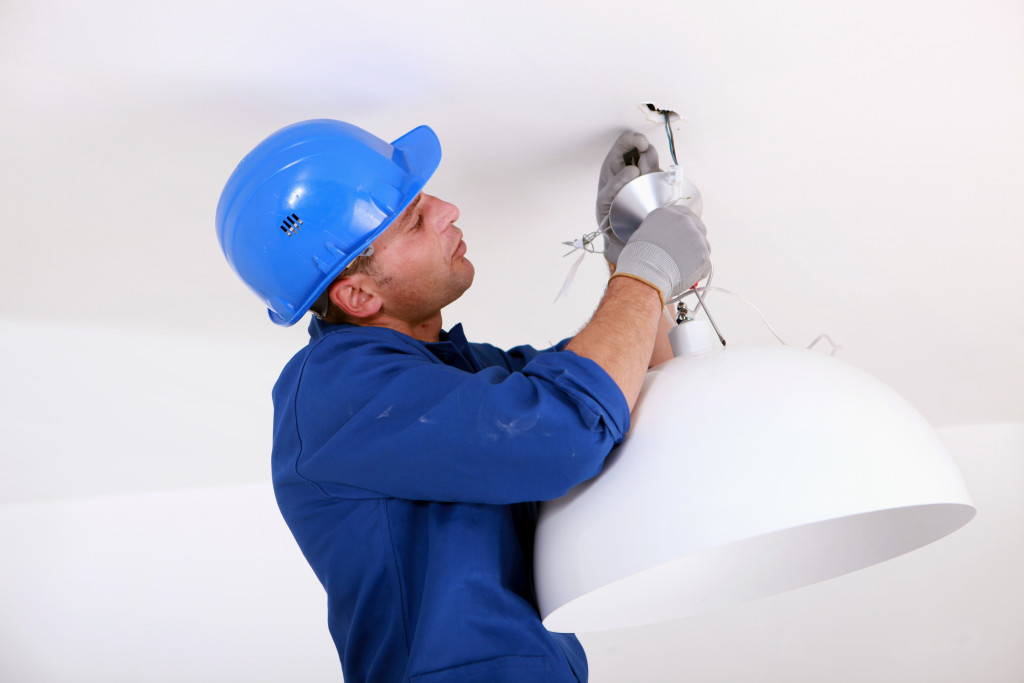 professional worker installing light 