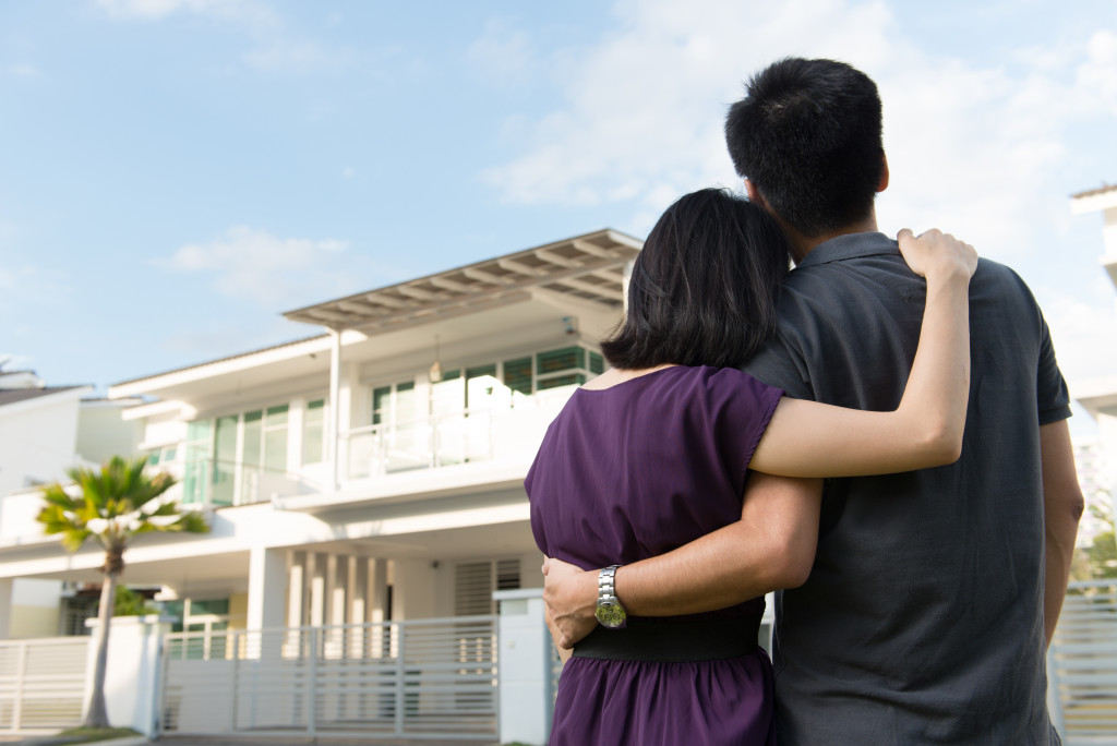 Young couple looking at their finished dream house.